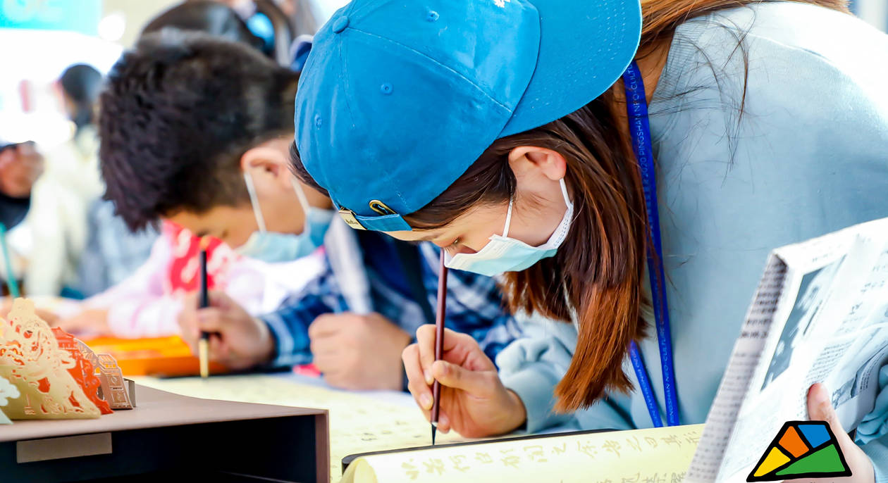 Visitors try Chinese calligraphy at the exhibition.