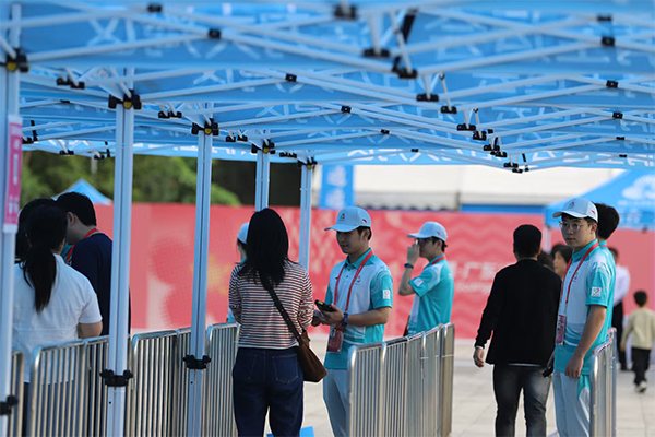 Staff check spectators’ tickets at the entrance of the Pingshan Sports Center Gymnasium.