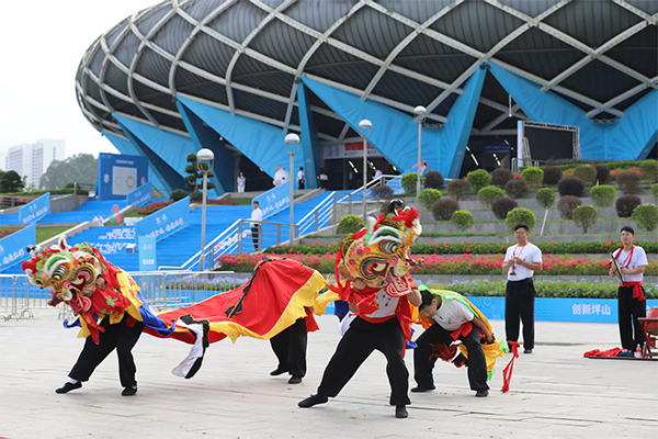 A qilin dance is performed outside the Pingshan Sports Center Gymnasium.